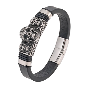 Punk style black leather men's bracelet with three silver skulls and magnetic clasp