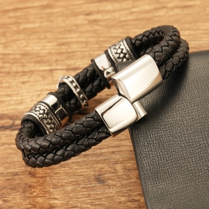 Close-up of men's black braided leather bracelet with silver magnetic metal clasp