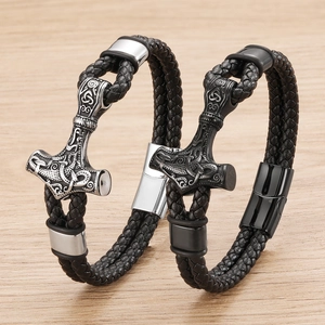 Close-up of Viking Mjolnir charm on braided leather bracelet with magnetic clasp