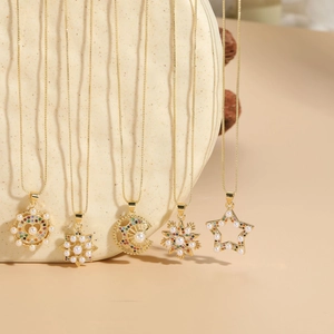 Detailed macro view of gold-plated necklaces with pearl and multicolored zircon star pendants