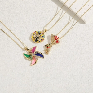 Detailed view of colorful windmill and bear pendants with zircon and enamel in gold