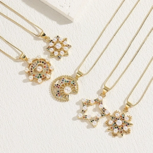 Golden necklace set with snowflake, star, and crescent pendants with pearls and zircons