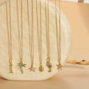 Detail view of 14K gold plated marine necklaces with zircon starfish and palm pendants