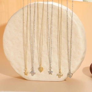 Vertical display of dainty gold and silver zircon pendant necklaces with star and heart motifs