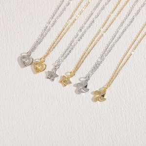 Set of minimalist gold and silver necklaces with zircon heart and windmill pendants