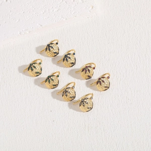 Detail of vintage round earrings with colorful cubic zirconia in leaf patterns