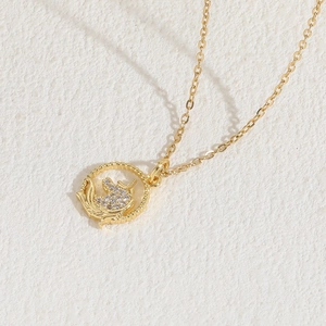 Luxury 14K gold plated unicorn necklace with sparkling white crystals on stone surface