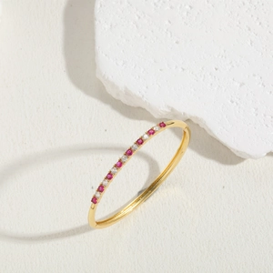 Detail of 18K gold-plated bangle with alternating pink zircon and white diamond stones