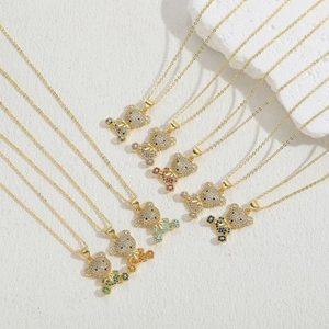 Macro detail of multicolored cubic zirconia teddy bear pendants with 14K gold plating