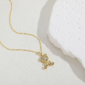 Macro shot of gold-plated teddy bear necklace with colorful cubic zirconia pavé stones