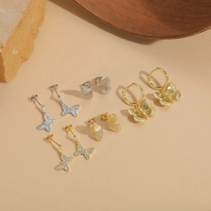 Elegant 14K gold plated butterfly earrings with sparkling cubic zirconia on beige stones