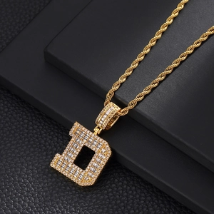 Close-up of gold letter D pendant with micro-pave cubic zirconia on a rope chain