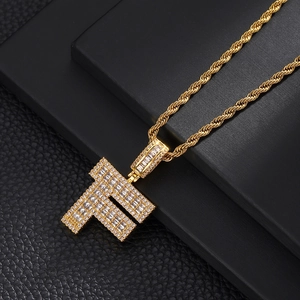Detailed macro view of gold-plated letter F pendant with glittering cubic zirconia stones