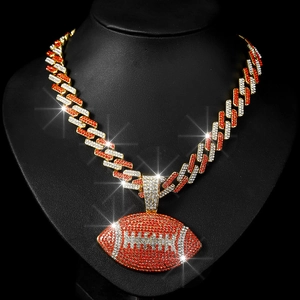 Detail of hip hop Cuban chain with sparkling crystal-encrusted rugby ball pendant