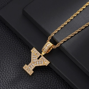 Macro shot of gold letter Y pendant with cubic zirconia on a classic twisted rope chain