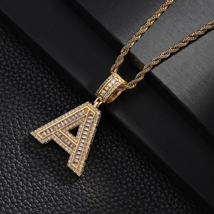 Gold plated letter A pendant necklace with cubic zirconia on black leather background
