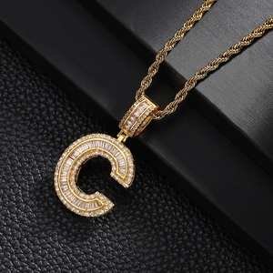 Macro shot of gold-plated letter C pendant with sparkling pavé cubic zirconia on rope chain