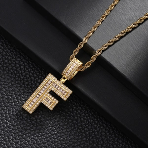 Close-up detail of gold plated letter F pendant necklace with micro paved cubic zirconia