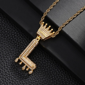 Macro d'un pendentif lettre L hip hop plaqué or avec couronne et zircons sertis