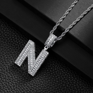 Detailed view of silver N-letter pendant with pave-set crystals and thick twist rope chain