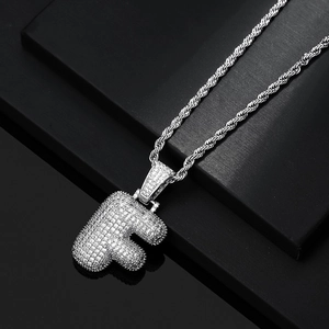 Close-up of iced out 3D letter F pendant with silver rope chain for hip hop style