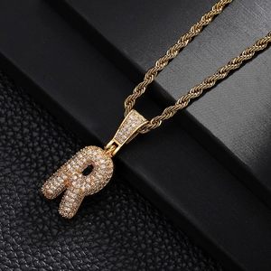 Detail of Letter R pendant in gold finish with sparkling pavé zircons on a rope chain