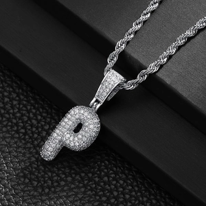 Macro shot of silver hip-hop letter P pendant with micro-paved zircons on a rope chain