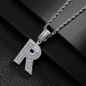 Close-up of hip hop silver letter R pendant with sparkling zircon inlays on a rope chain