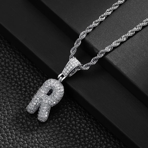 Close-up of hip-hop letter R pendant with cubic zirconia and silver rope chain