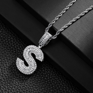 Macro shot of silver S letter pendant with baguette zircons on a classic rope chain
