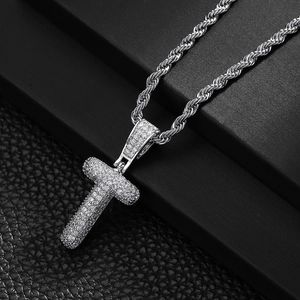 Close-up of hip hop letter T pendant with iced out cubic zirconia on twist rope chain