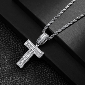 Close-up of hip hop silver T-letter pendant encrusted with cubic zirconia on a rope chain