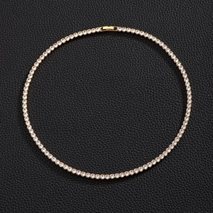 Top view of gold-plated tennis necklace with round zircon crystals on black leather
