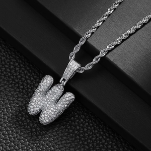 Macro shot of hip hop letter W pendant with sparkling zircon micro-paving and twisted rope chain