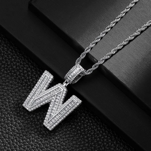 Close-up of hip hop silver W letter pendant with cubic zirconia on a rope chain
