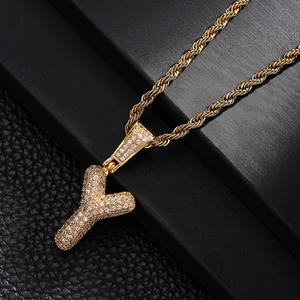 Macro shot of gold-plated letter Y pendant with shimmering pavé zircon on a rope chain