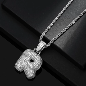 Detail of Hip Hop bubble R letter pendant with zircon pavé and thick rope chain