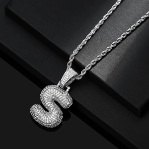 Detail of silver bubble letter S pendant with pavé cubic zirconia on rope chain