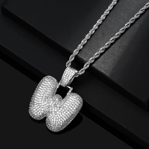 Macro detail of silver hip hop W letter pendant with sparkling zircon paving on rope chain