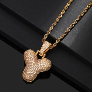 Detail of a gold-plated capital letter Y pendant necklace with cubic zirconia micro-pave