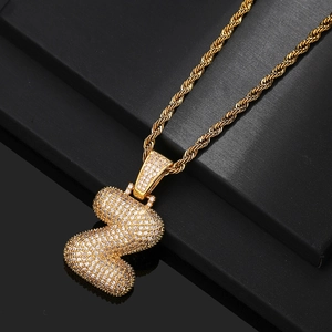 Close-up of golden bubble letter Z pendant with micro-pave zircons on rope chain