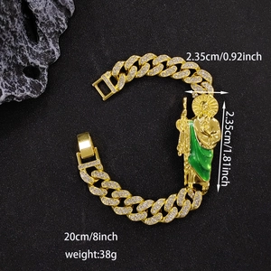 Detail view of gold Cuban link chain with St. Jude pendant and green enamel inlay