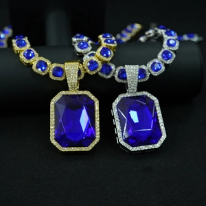 Close-up of iced out Cuban chain necklace with large blue square octagon gemstone
