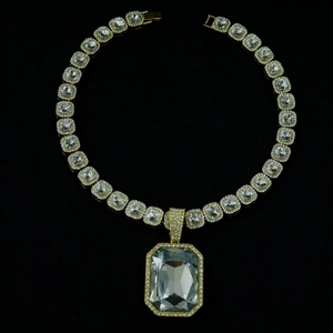 Macro shot of Cuban chain necklace with square cut crystals and large radiant pendant