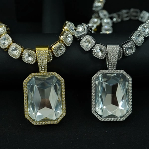 Close-up of gold and silver hip hop pendants with large square crystals and iced-out chains