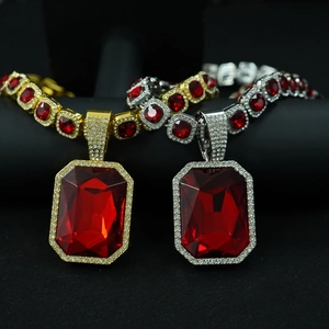 Detail of gold and silver cuban links with large rectangle red gemstone pendants