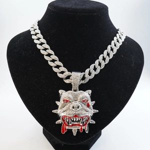 Detail of hip hop bulldog pendant with sparkling rhinestones and red blood dripping accent
