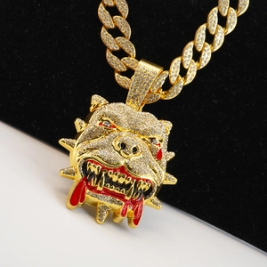 Macro shot of gold hip hop bulldog pendant with sparkling rhinestones and red enamel details