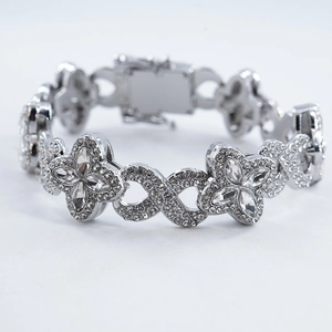 Icy silver Cuban chain bracelet featuring clover and infinity charms with clear zircons