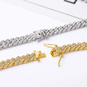 Detail of 9mm gold and silver iced out Cuban link chains with crystal box clasp